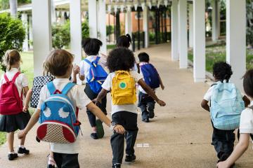 Group of diverse kindergarten students walking together
