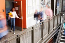 Busy High School Corridor During Recess With Blurred Students And Staff